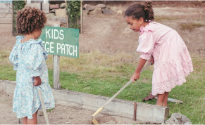 Children learning gardening skills in a school garden